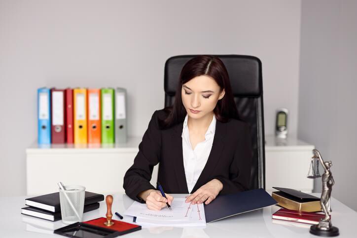 A female law clerk preparing legal documents in an office after completing her law clerk diploma program
